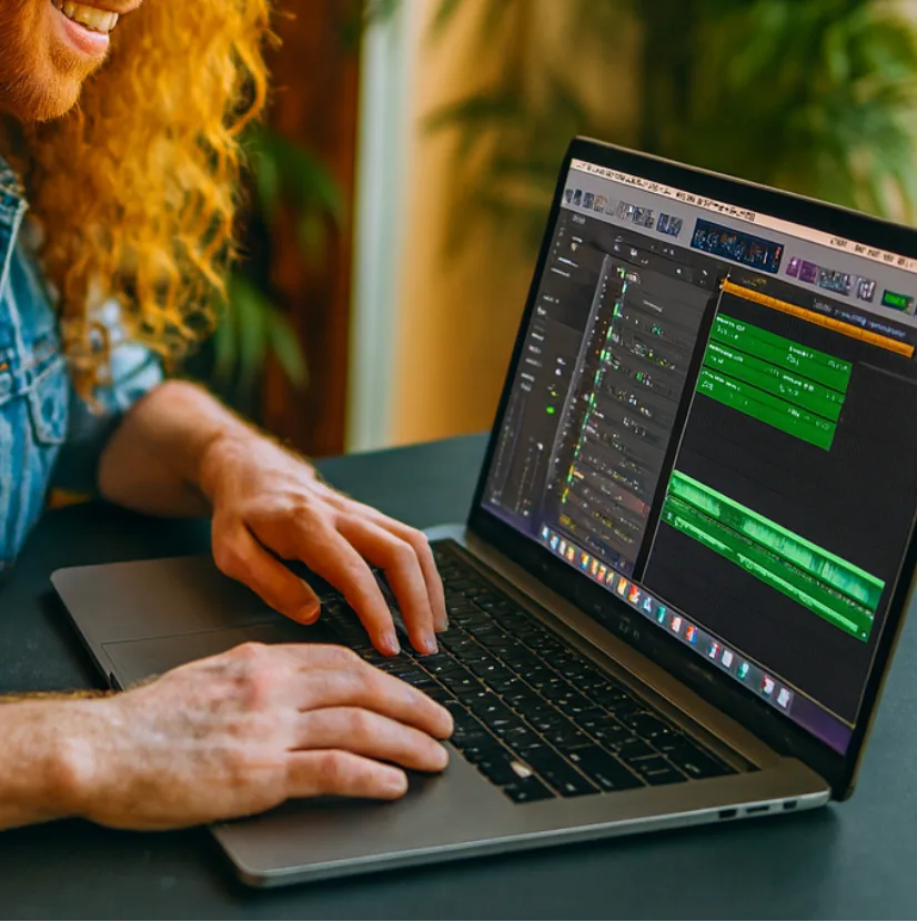 Sean Ashe at a laptop with a Logic Pro session open
