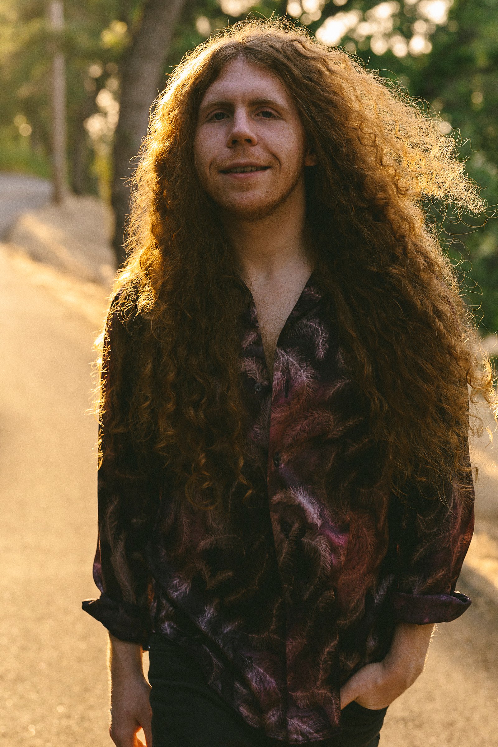 Outdoor portrait of Sean Ashe in warm golden-hour backlight.