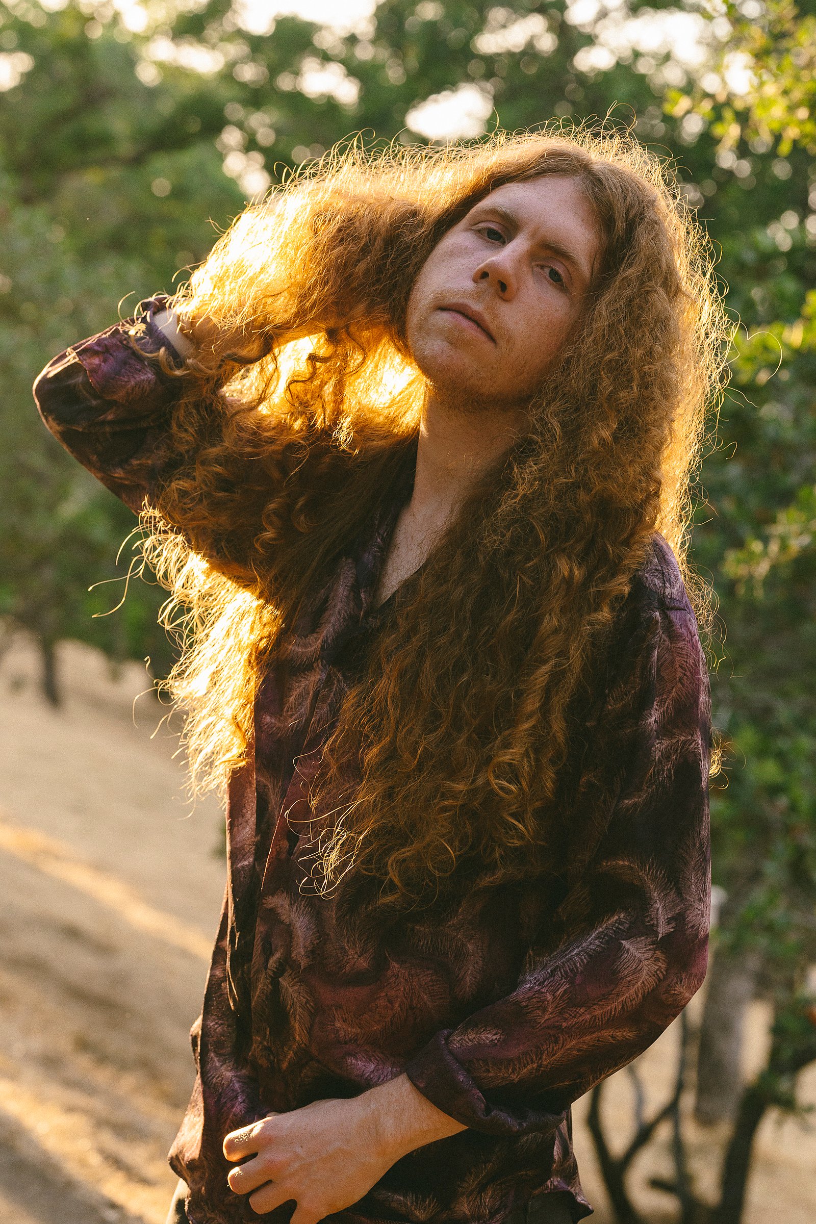 Backlit outdoor editorial portrait of Sean Ashe.
