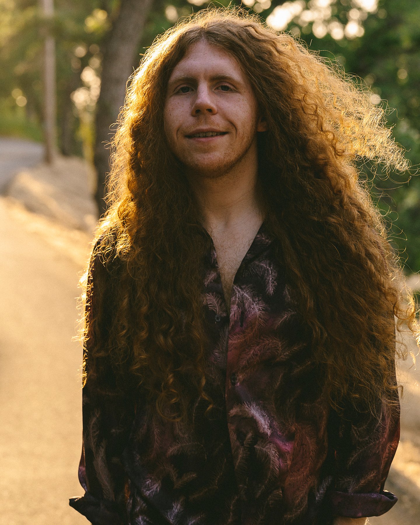 Outdoor portrait of Sean Ashe in warm golden-hour backlight.