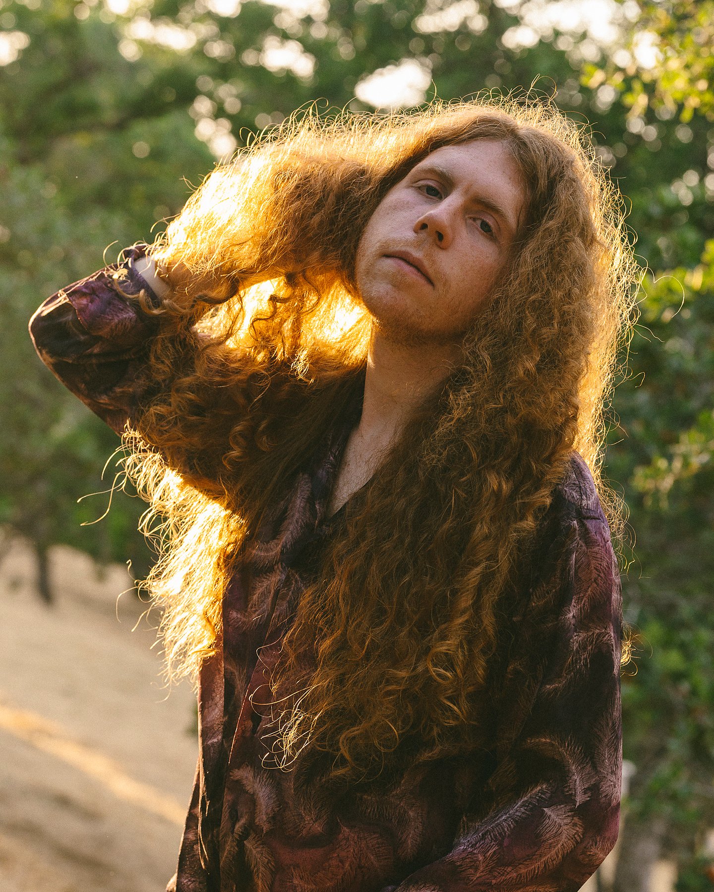 Backlit outdoor editorial portrait of Sean Ashe.
